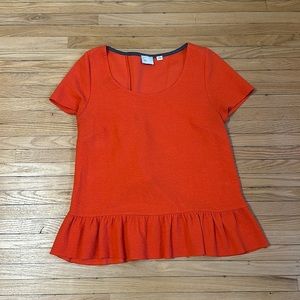 Orange ruffled top from Anthropologie.